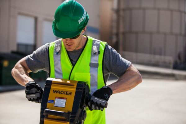 construction worker using a jackhammer while wearing NRR 27 ear plugs